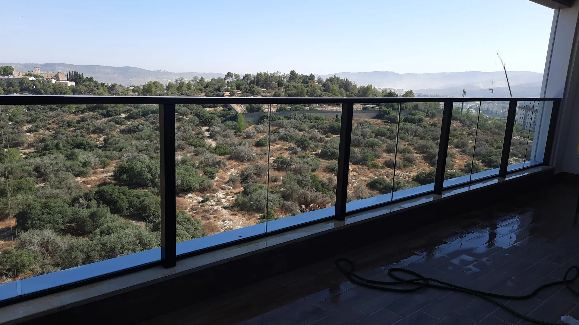 Clean balcony glass with a view over Beit Shemesh